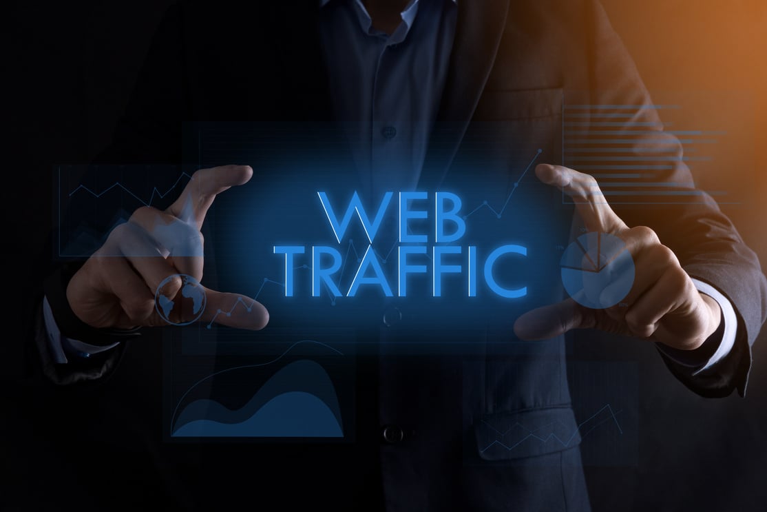 Business man hands holding inscription WEB TRAFFIC with different graphs on the background.successful business concept.Website traffic improvement.SEO